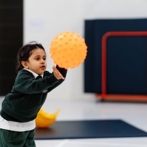 Prep school nursery girl catching ball