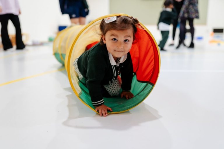 Prep school nursery girl in play tunnel