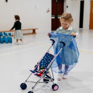 Prep school nursery - girl with pushchair
