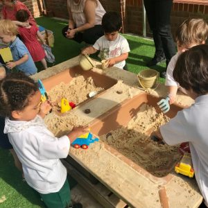 Prep school pupils playing in sandpit