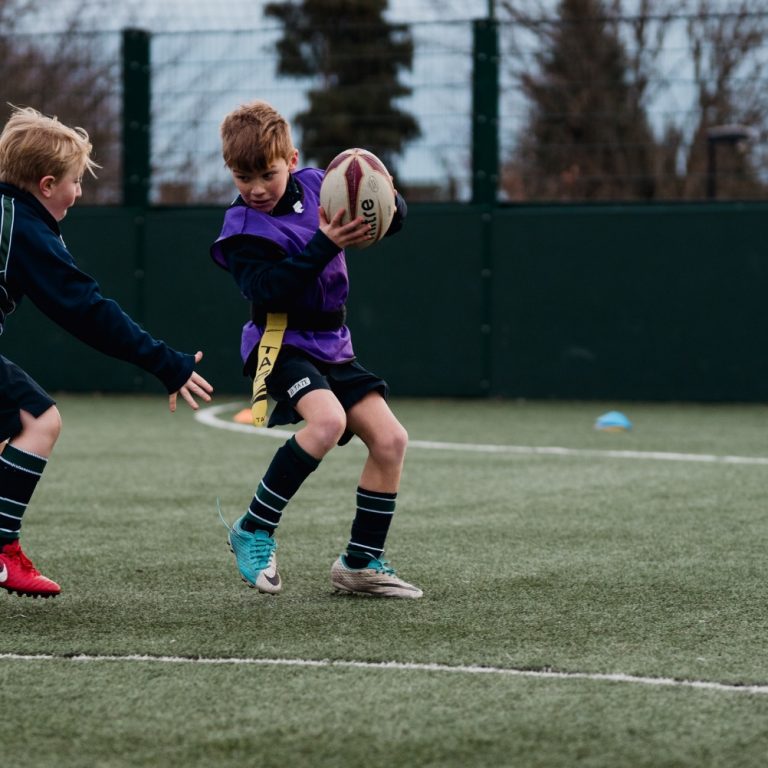 2 students playing tag rugby