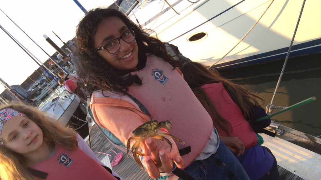 girl holding a crab
