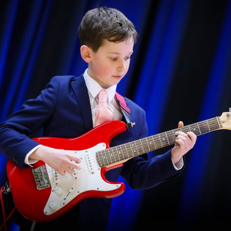 boy playing the electric guitar