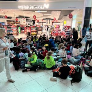 group of students sat on the floor by duty free