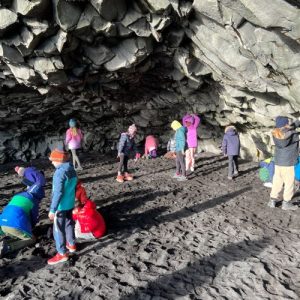 students foraging in a cave