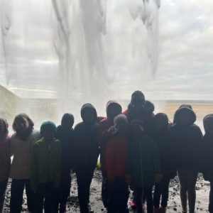 Students stood in front of a waterfall
