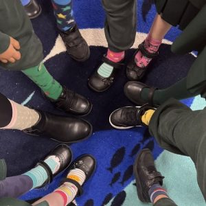 students showing their socks and shoes