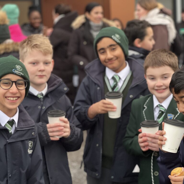students holding hot drinks